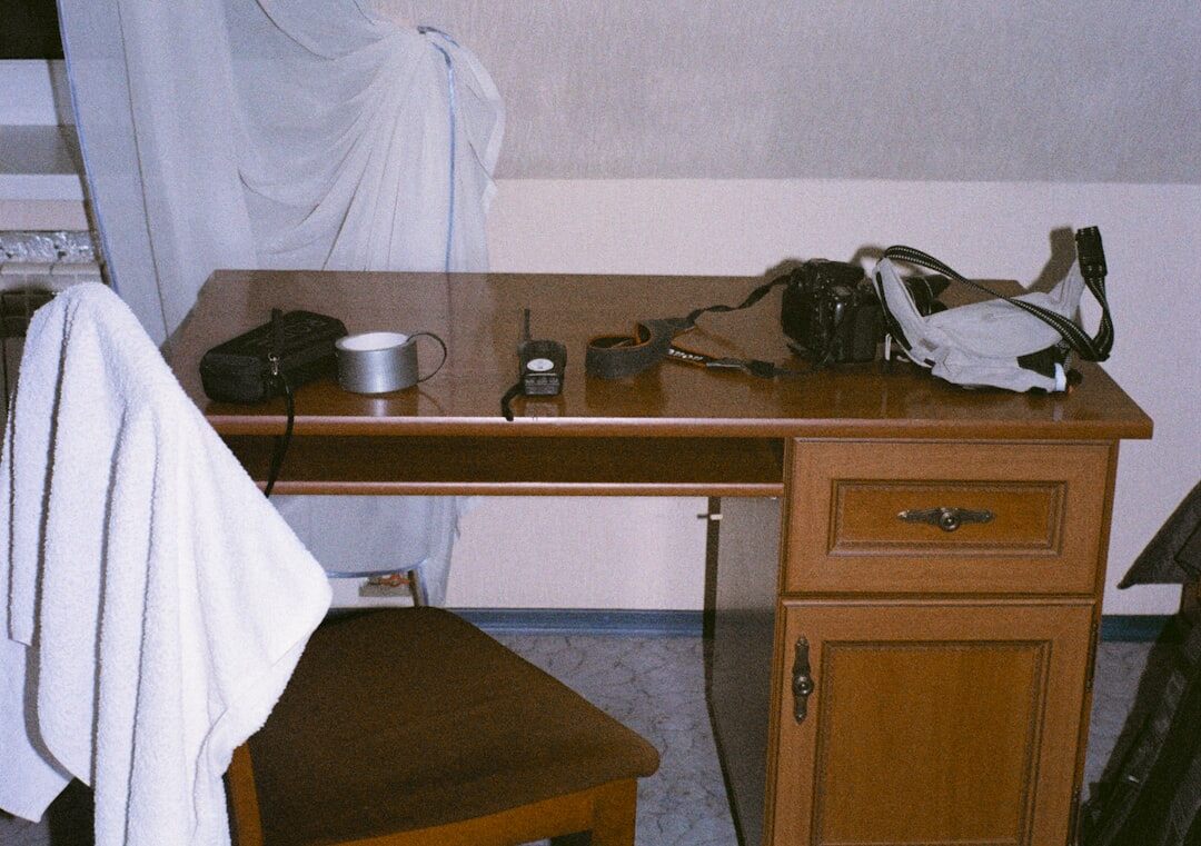 Photo of a photographer's desk with prints and a notebook